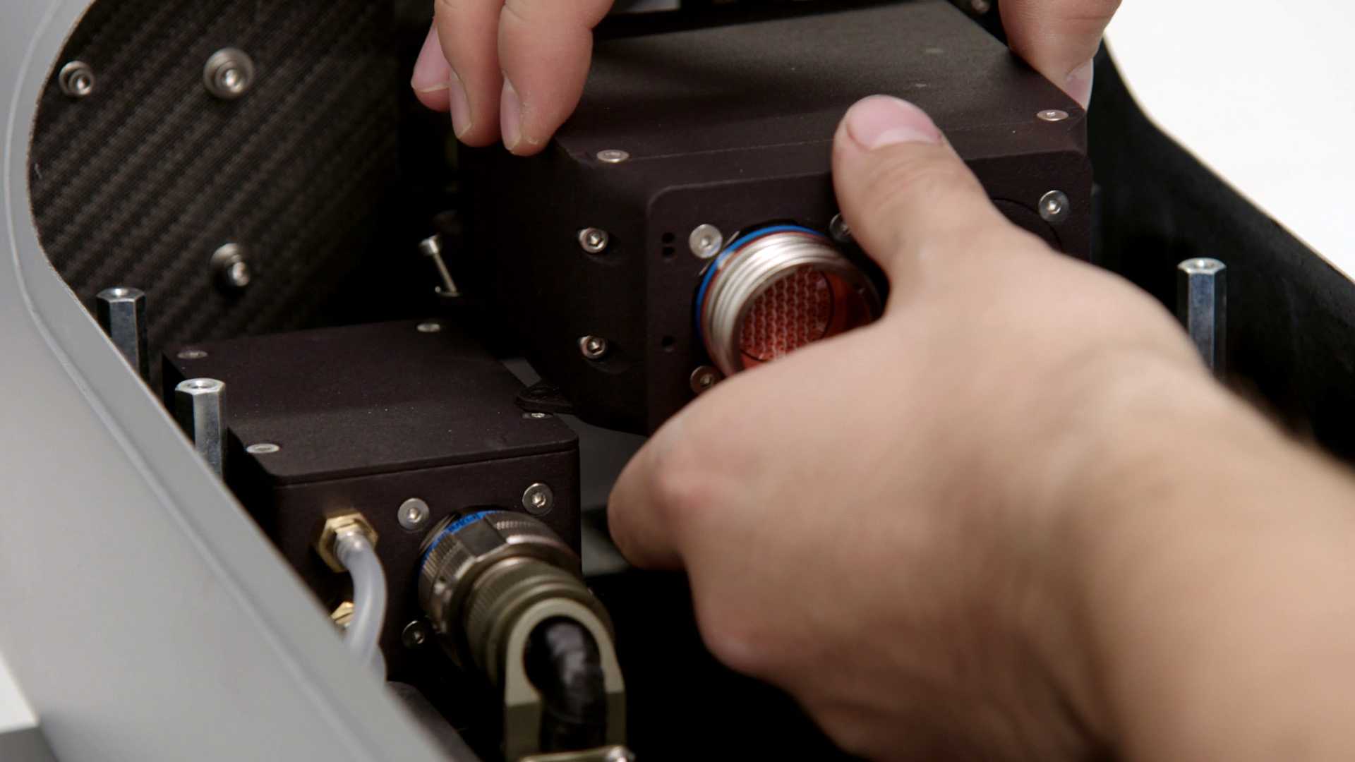 An engineer assembling a component